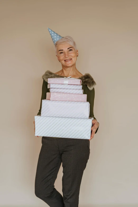 an elderly woman holding stacks of folded gifts