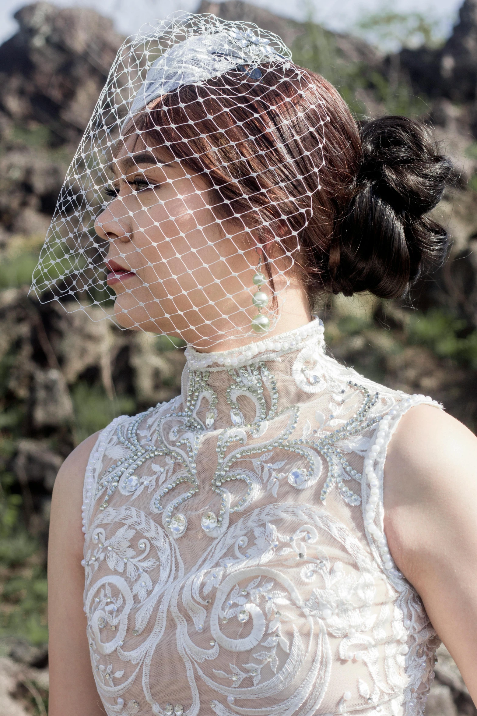 the back of a bride's dress and veil with intricate embroidery and crystals