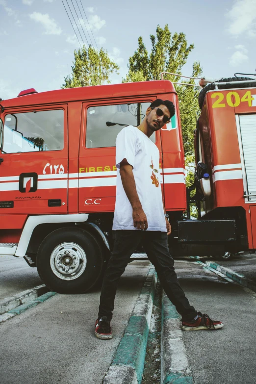 a man walking across a street in front of a large red truck