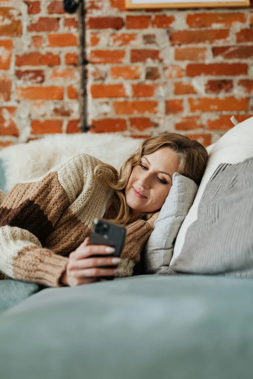 a woman is smiling while laying on the bed