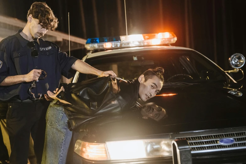 a police officer helping a man in a car