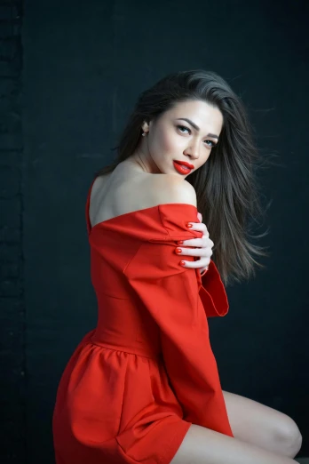 a woman with long hair posing in red