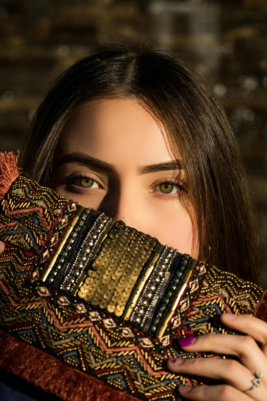 a woman holding a piece of fabric up to her face