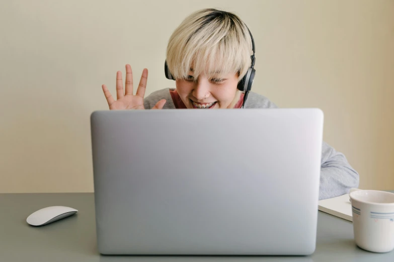 a woman wearing headphones is in front of a laptop