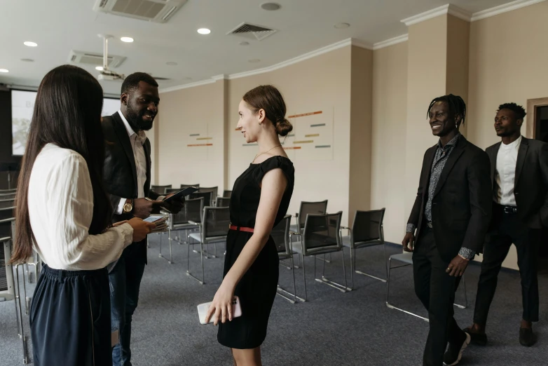 five people standing in a room together