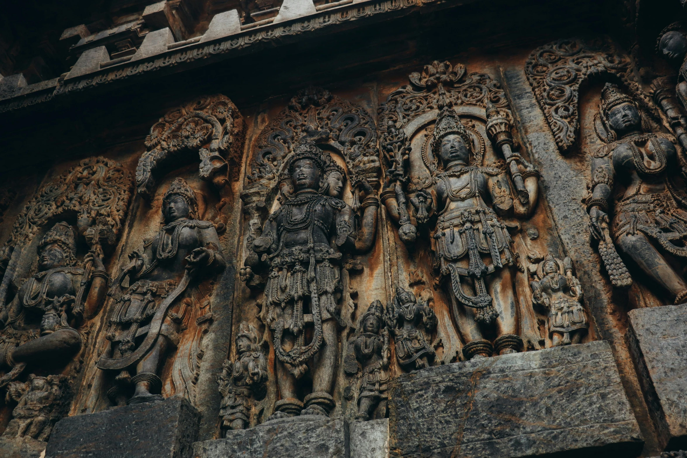 a number of statues on the side of a building