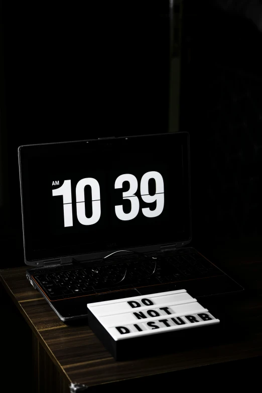 a laptop computer sitting on top of a wooden desk