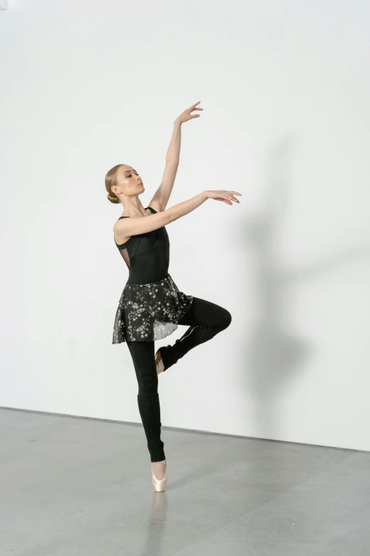 a dancer doing ballet poses in a white studio