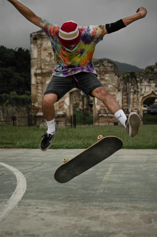 a man in an abstract t - shirt is jumping with his skateboard