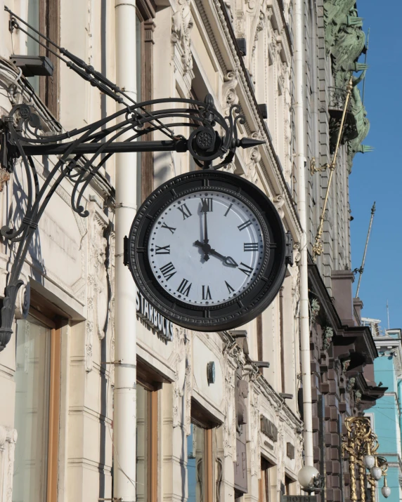 a black and white clock on the outside of a building