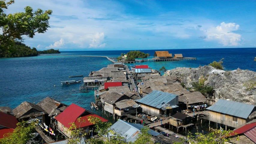 some houses sitting on top of a rocky outcrop