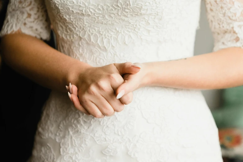 brides holding hands during their wedding ceremony