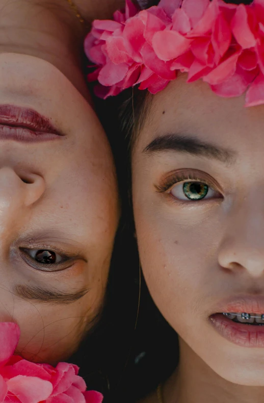 two young ladies pose with flower garlands on their heads