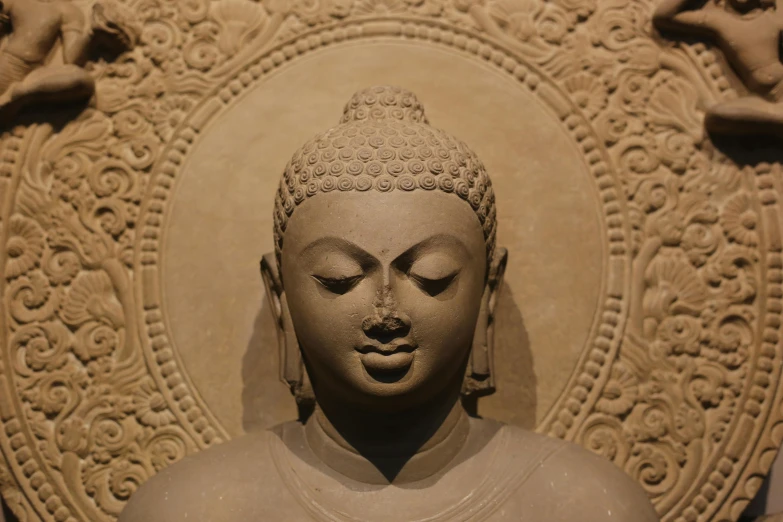this sculpture is of an asian buddha