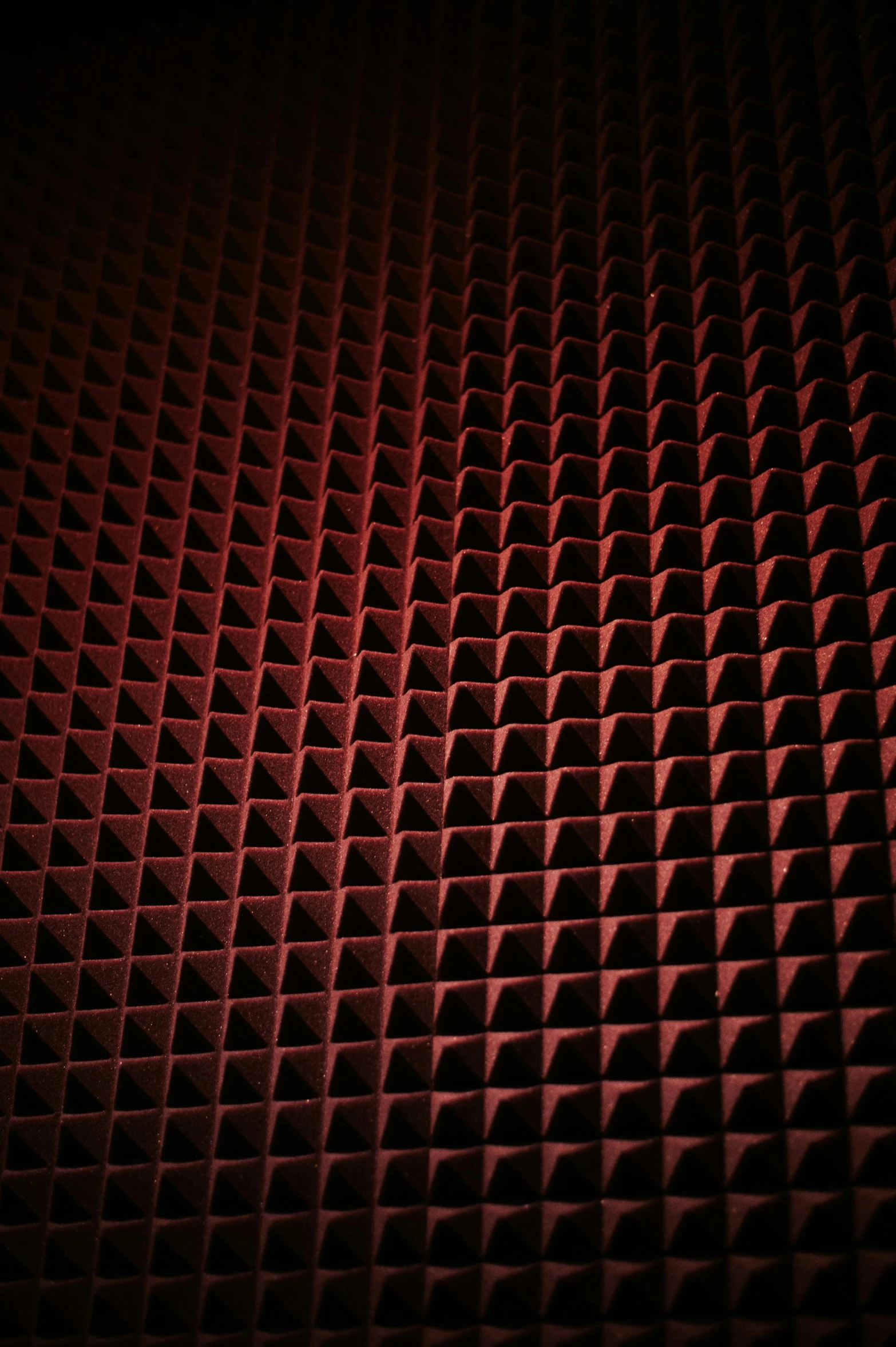 dark background image of a red wall with a small grid