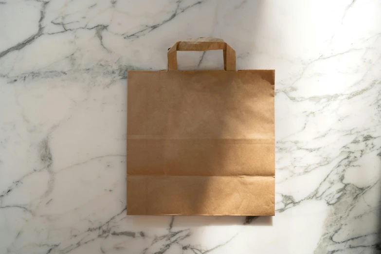 brown paper bag sitting on a white marble counter