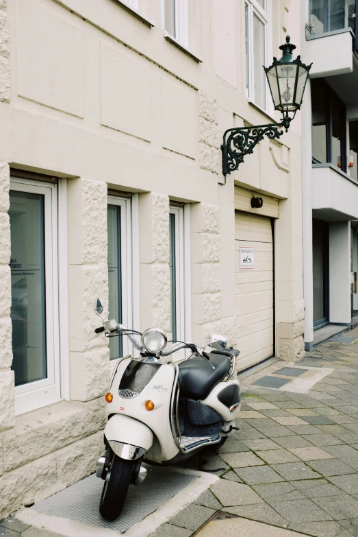 a white scooter parked on the side of a road