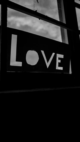a close up of a window with the word love painted on it