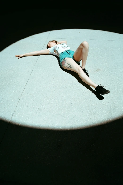 a woman in a short swimsuit laying down and stretching