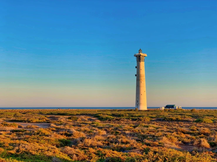 a light tower sits in an open field