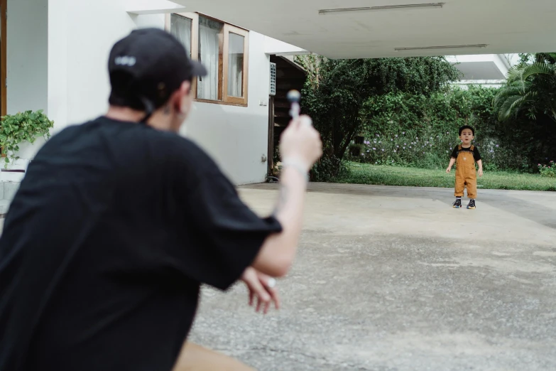 a man taking a picture of the back of his friend in a courtyard