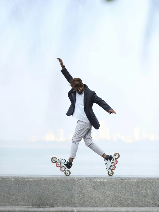 boy on skateboard and wearing grey blazer with red and white shoes