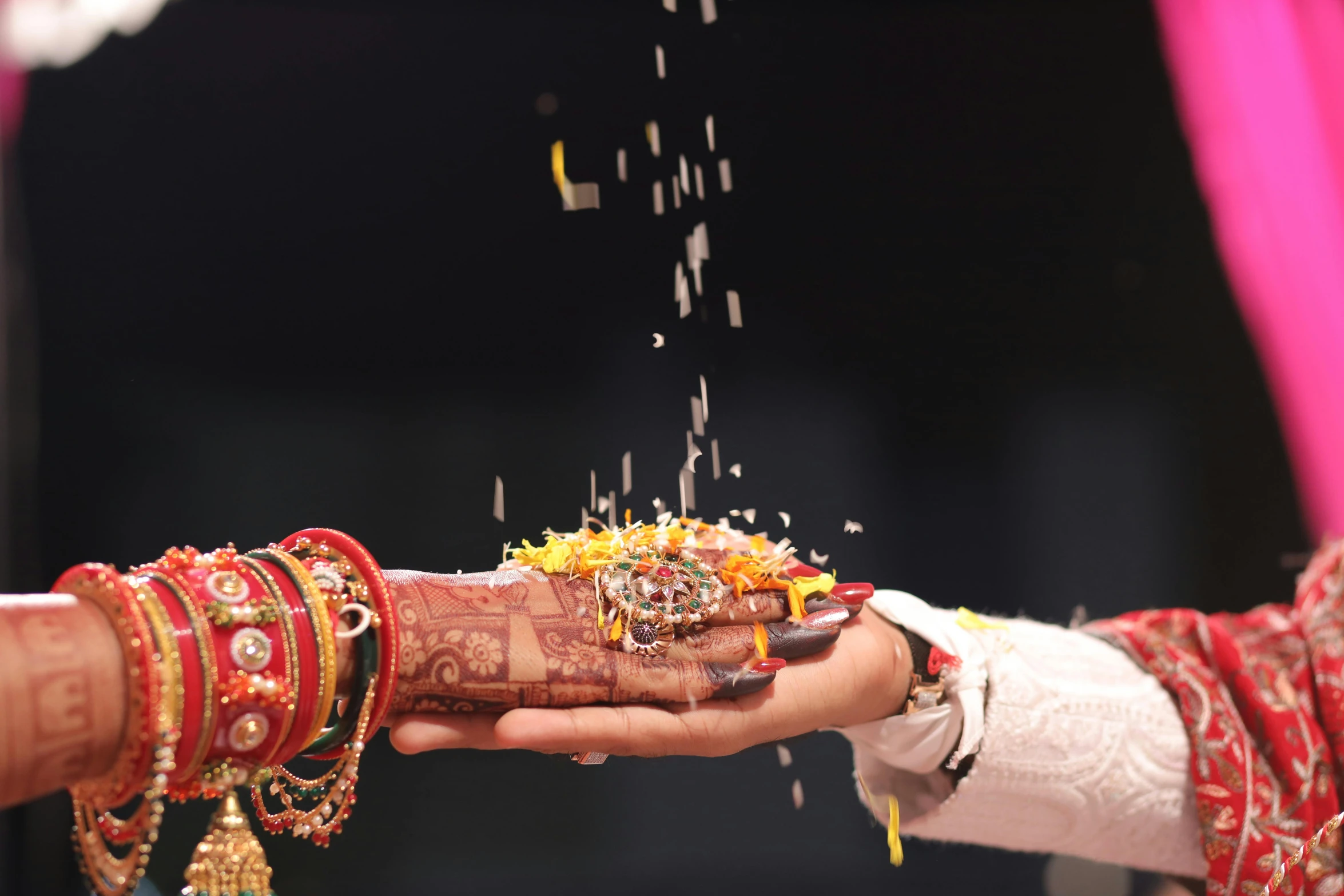 a close up of a person wearing a wedding ring holding another hand