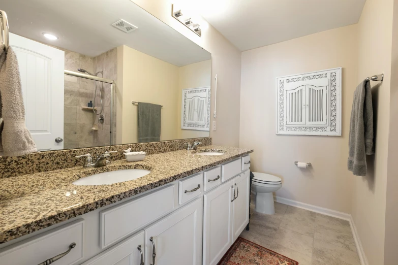 the bathroom has two sinks and a large mirror