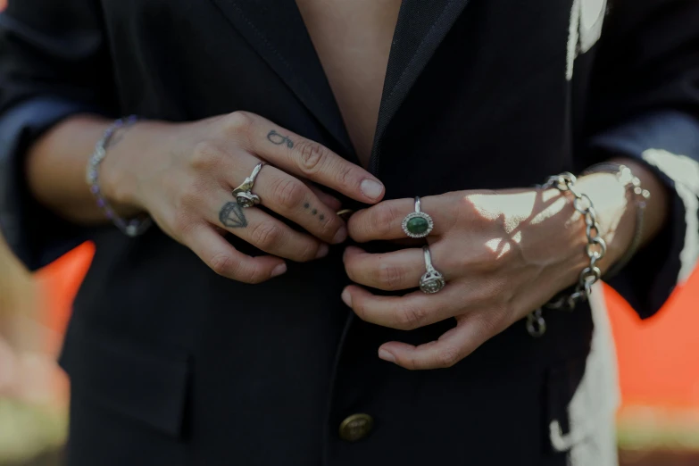 a person wearing two different rings on their fingers