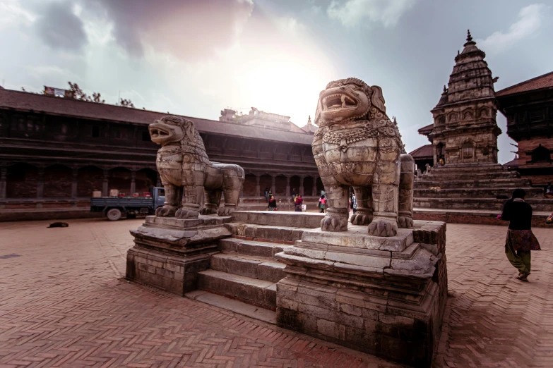 a person walking up stairs towards a statue