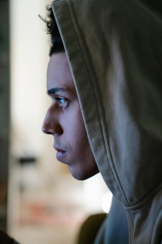 a closeup of a person wearing a hooded sweatshirt