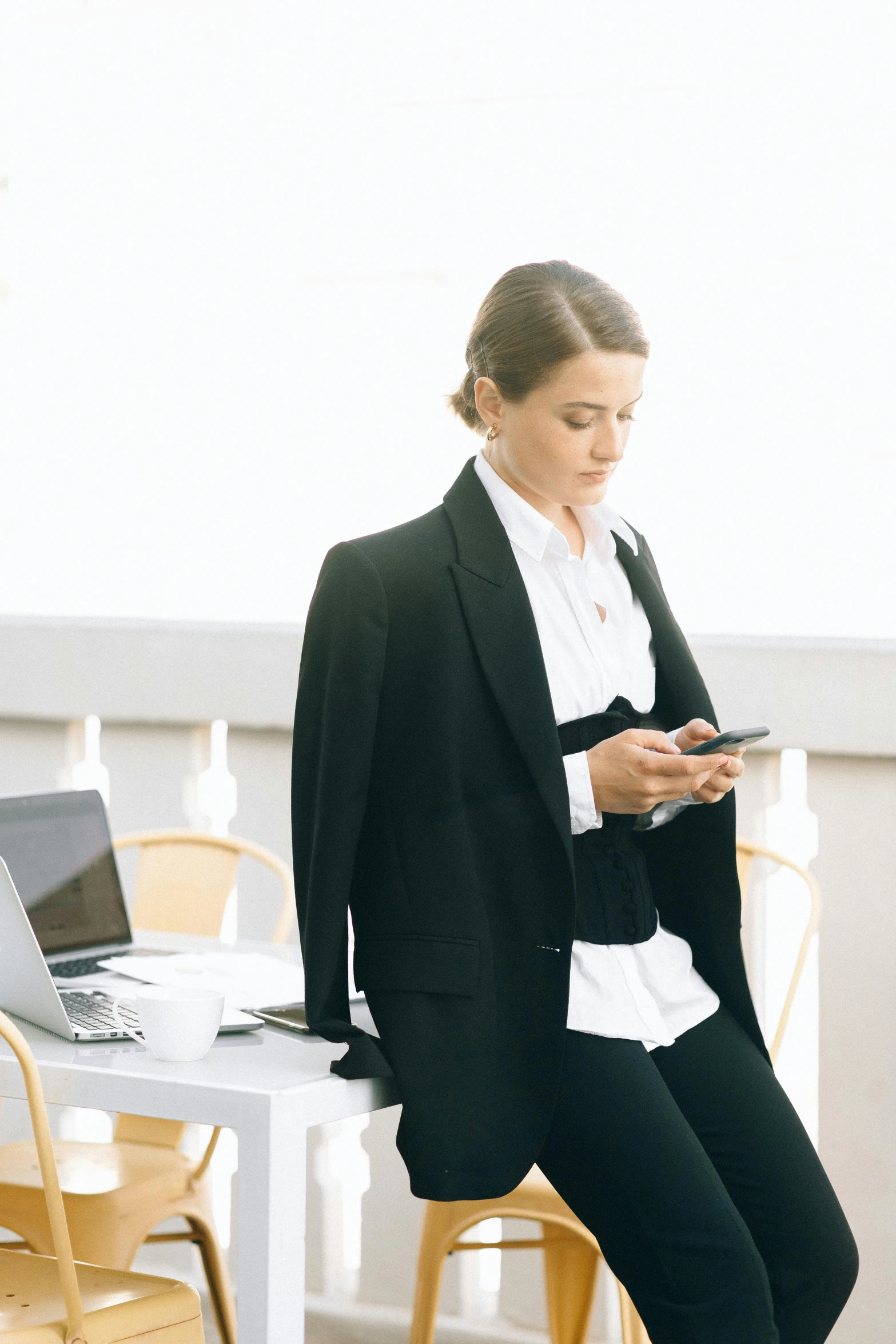 a woman is sitting on the back of a chair