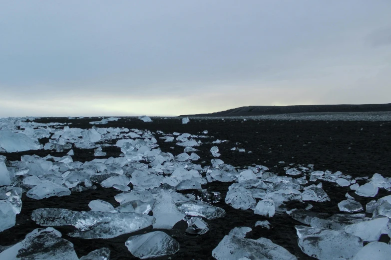 large pieces of ice sitting on the side of a mountain