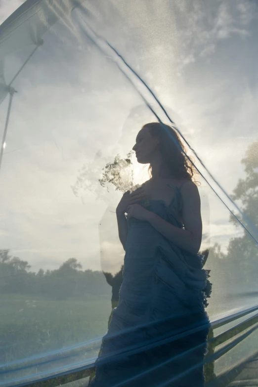 the woman is wearing a dress and holding flowers in her hands