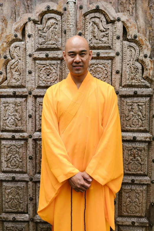 the monk is posing with his hands in his pockets