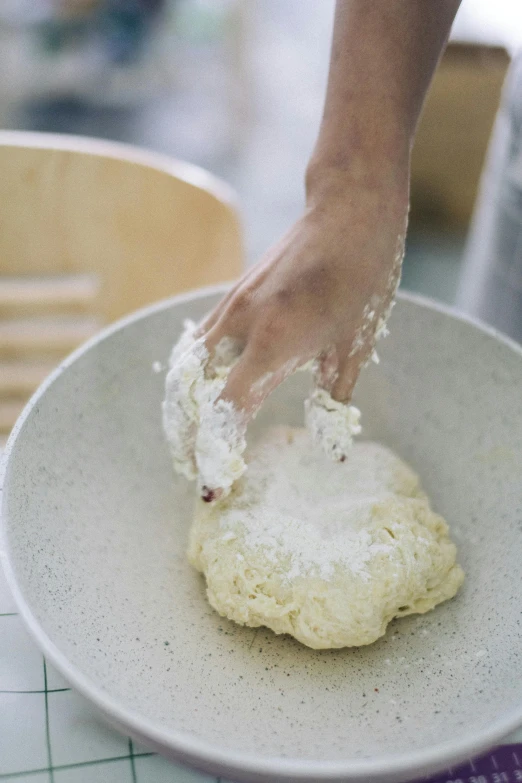 there is a person putting the batter on top of the dough