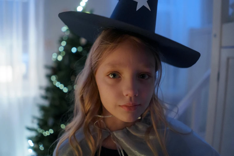 a little girl in a witch costume