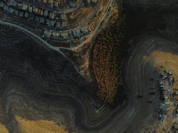 an aerial s shows a residential area and surrounding trees