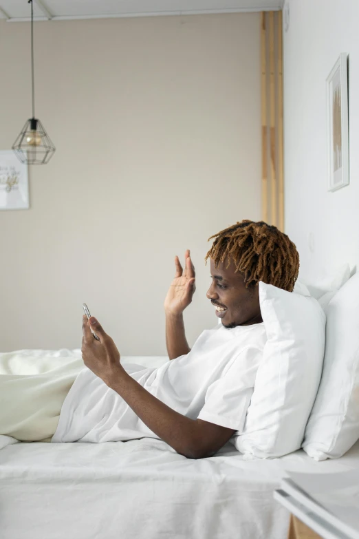 a person on the bed with a cell phone in hand