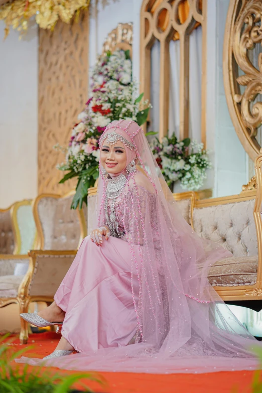 bride in pink traditional wedding dress posing for po