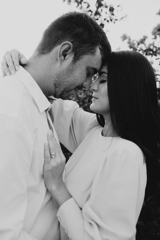 black and white po of a man kissing a woman