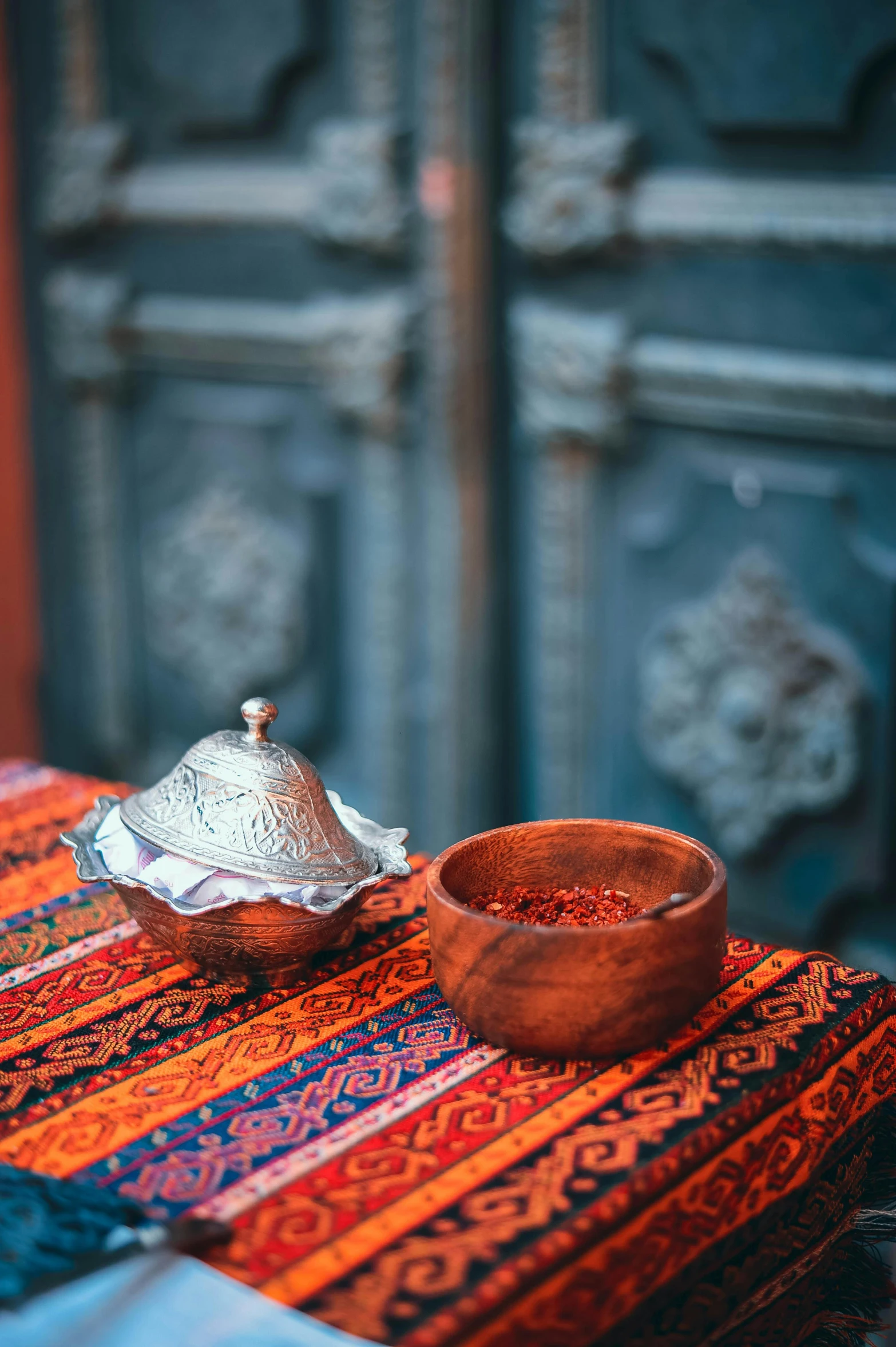 an old wood bowl sitting on a colorful table