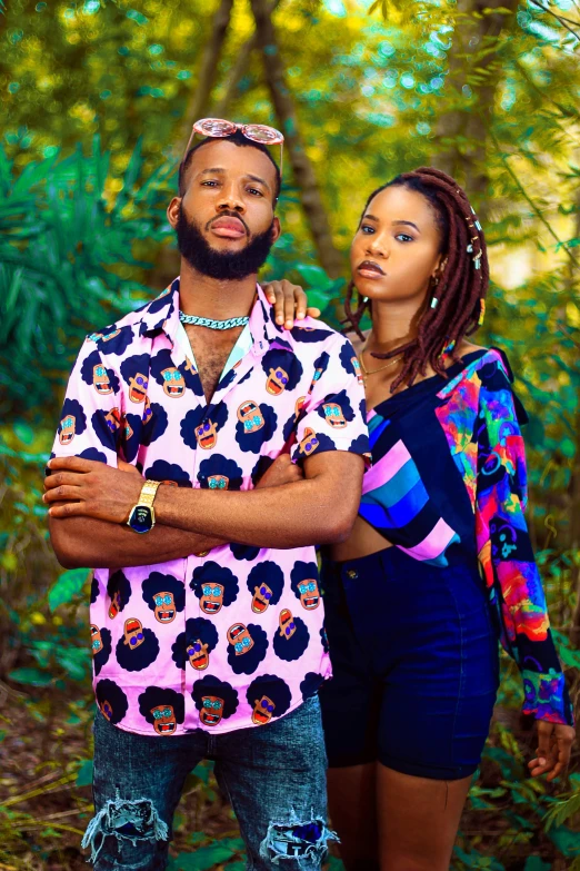 a couple posing in front of a forest for an image