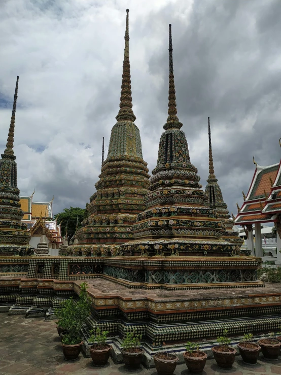 large ornate buildings surrounded by green and tan pots