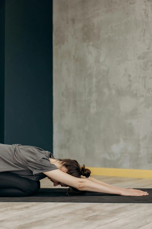 a woman is doing yoga on the floor