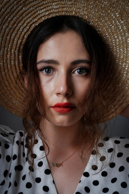 woman with large straw hat over her head