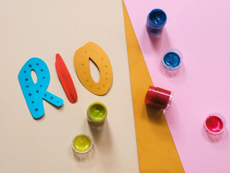 a colorful paper art with the numbers and paint bottles