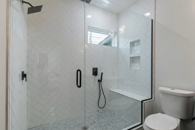 a bathroom with a glass shower and white tile floors