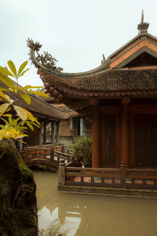 a building with lots of water and trees around it