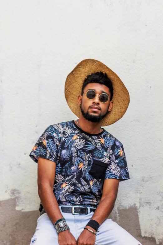 man wearing sunglasses and a straw hat